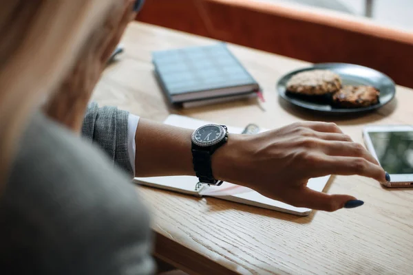 Time management, planning, Stop Wasting Time, use time productively and efficiently. Woman looking on alarm watch to managing time for organization of working process sitting in workplace