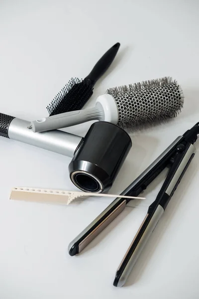 Hairdressing Tools and Equipment. Hair dryer, Paddle Brush, variety of combs, Water Bottle, Round Brush, texture iron or mini crimping iron — Stock Photo, Image