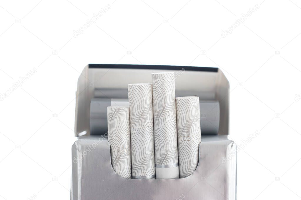 Opened packet of nondescript generic cigarettes with four pieces sticking out close up studio shot isolated on white.