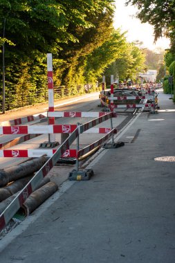 Road construction renewal site on a street in Europe with barricades and detours. No people sunset light.