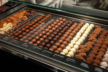 Vitrindeki el yapımı trüf mantarları ve pralinler. Kapat, kimse yok.