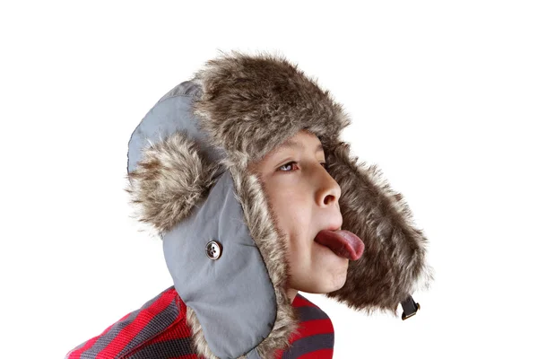 Boy playing around in furry hat Royalty Free Stock Images