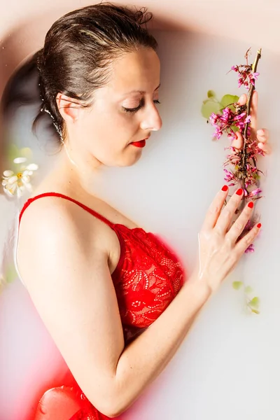 Woman Taking Bath Bathtub Filled Milk Dressed Red Babydoll Flowers — Stock Photo, Image