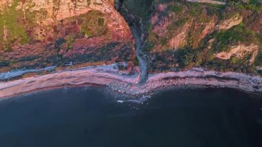 Güneş batarken, okyanusun üzerindeki engebeli kayalıkları ve evleri aydınlatan, nefes kesici Lunada Körfezi Kanyonu 'nun alçak hava akıntısı, Palos Verdes Evleri, Kaliforniya