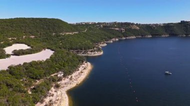 Güneşli bir sonbahar gününde, engebeli uçurumlar ve çarpıcı göl evleri Austin, Teksas 'ta nefes kesen Travis Gölü' nün üzerinde.