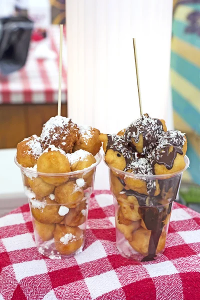 Fritters with sugar and chocolate — Stock Photo, Image