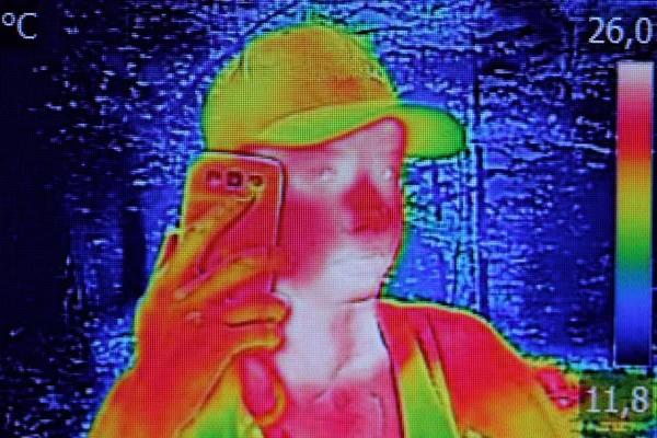 Infrared image showing the heat emission when Young girl used sm — Stock Photo, Image