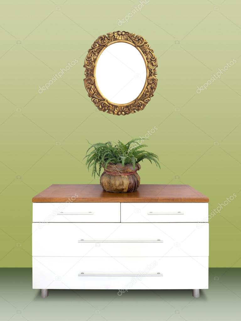 Modern chest of drawers and gilded Frame on wall
