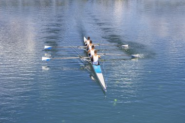 Four men rowing  clipart