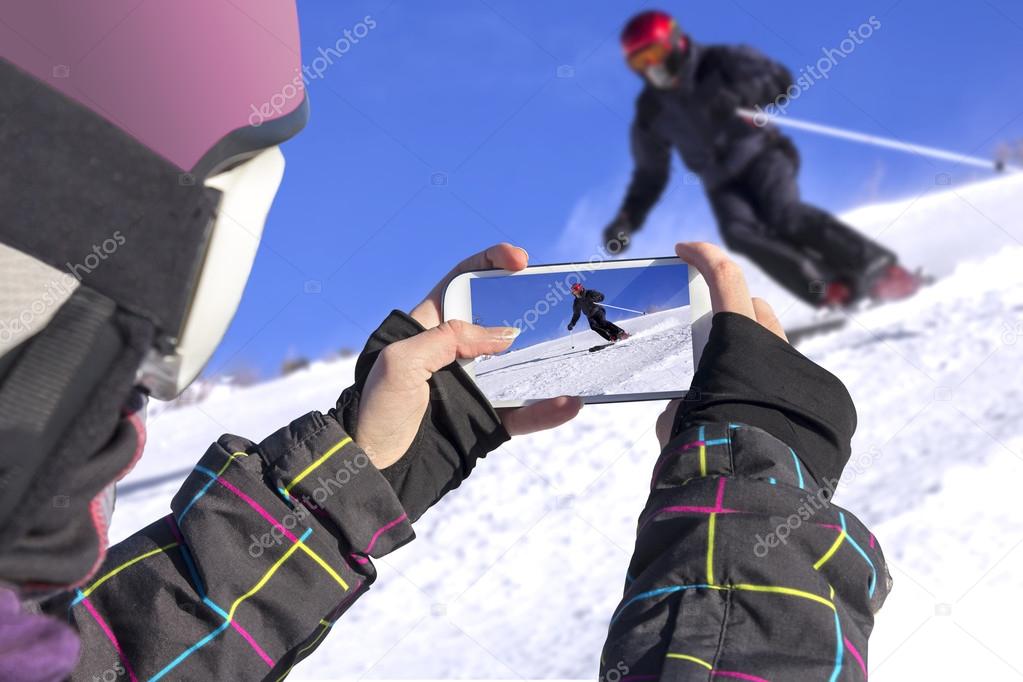 Photographed skiers with mobile phone