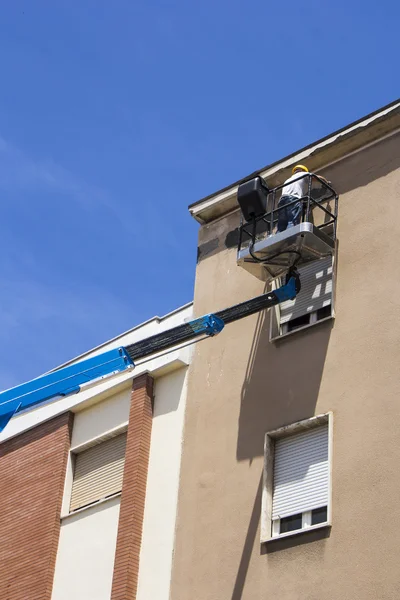 Worker on lift bucket — Stock Photo, Image