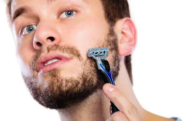 Young man with beard holding razor blade — Stock Photo, Image