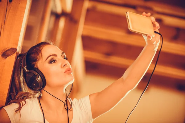 音楽を聴くヘッドフォンのスマート フォンを持つ女性. — ストック写真