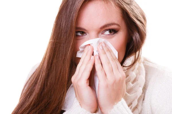 Woman sneezing in tissue — Stock Photo, Image