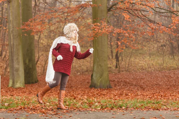 Mode kvinna kör i höst park skog. — Stockfoto