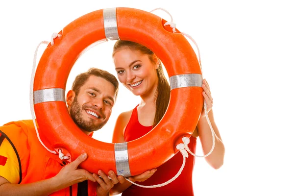 Lifeguards in life vest with ring buoy having fun. — Stock Photo, Image