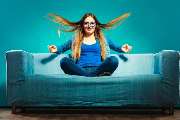 Girl wearing denim sitting on couch — Stock Photo, Image