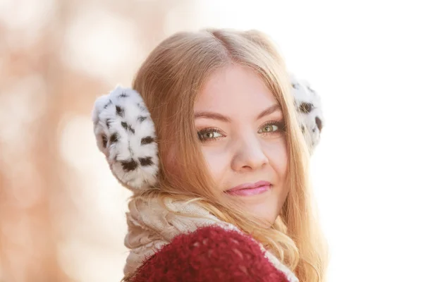 Portrait of pretty smiling woman in fur earmuffs. — Stock Photo, Image