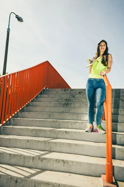 Girl on stairs with skateboard. — Stock Photo, Image