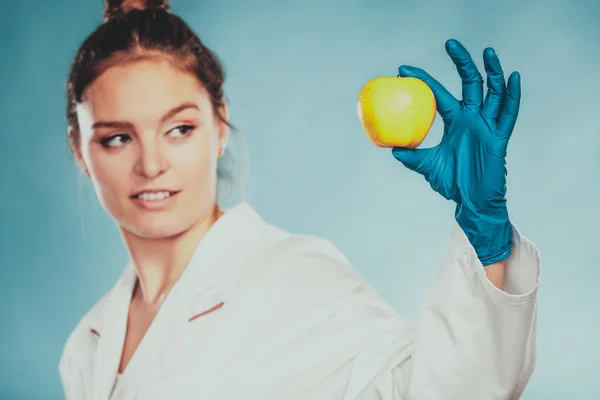 Scientist doctor with rotten apple. GM food. — Stock Photo, Image