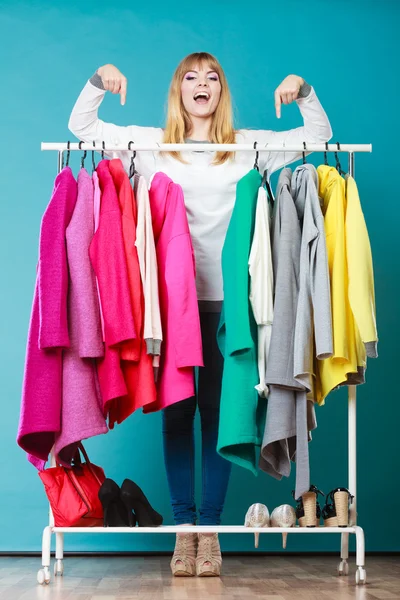 Woman pointing at clothes in mall or wardrobe. — Stok fotoğraf