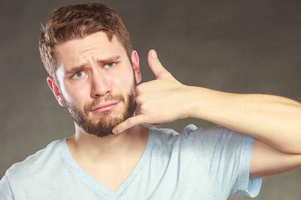 Man showing call me gesture. — Stock Photo, Image