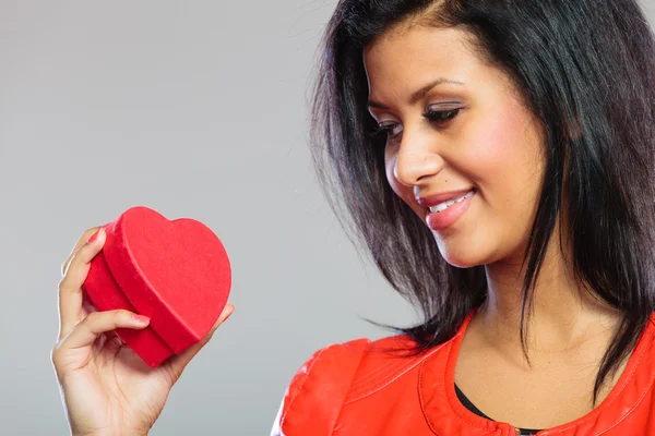Girl in red holding heart gift — Stock Photo, Image