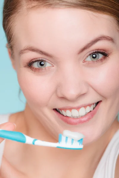 Žena drží kartáček se zubní pastou čištění zubů — Stock fotografie