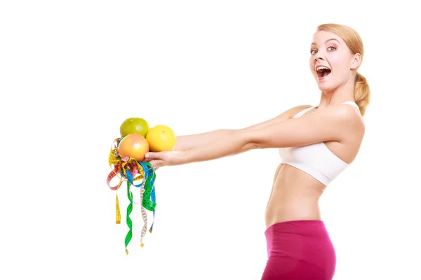 Happy woman holding grapefruits and tape measures. — Stock Photo, Image