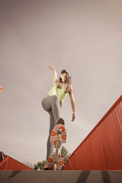 Teen girl skater riding skateboard on street. — Stock Photo, Image