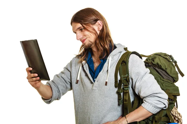 Backpacker man met pc-tablet surfen op internet. — Stockfoto