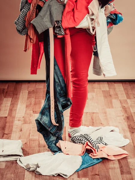 Woman hold lot of colorful clothes. — Stock Photo, Image