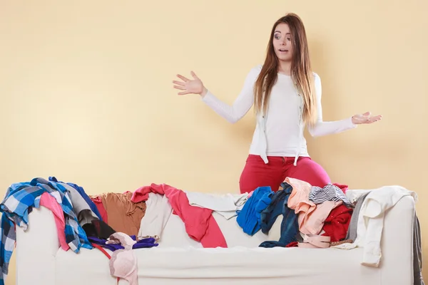 Helpless woman sitting on sofa in messy room home. — Stock Photo, Image