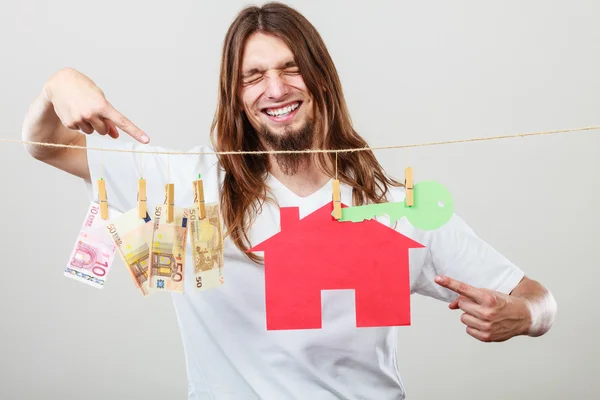 Man seller with money and house — Stock Photo, Image