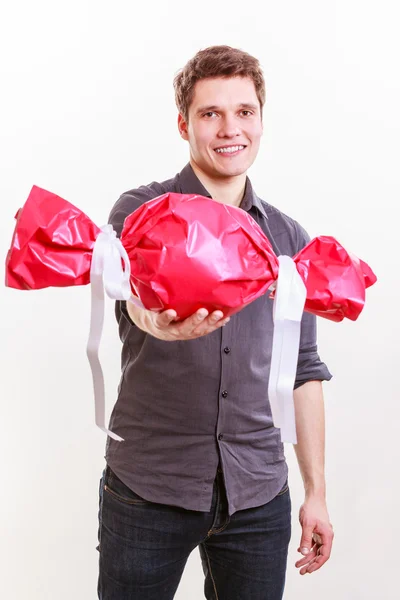 Man with big red candy. — Stock Photo, Image