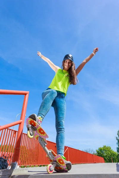 Dospívající dívka bruslař na koni skateboard na ulici. — Stock fotografie