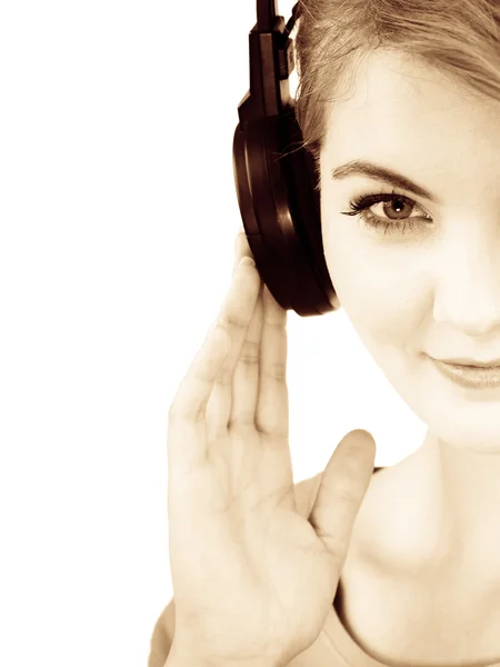 Woman in big headphones listening music isolated — Stock Photo, Image