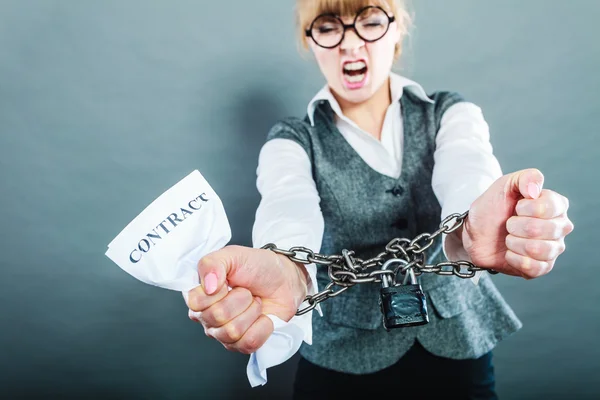 Furious woman with chained hands and contract — Stock Photo, Image