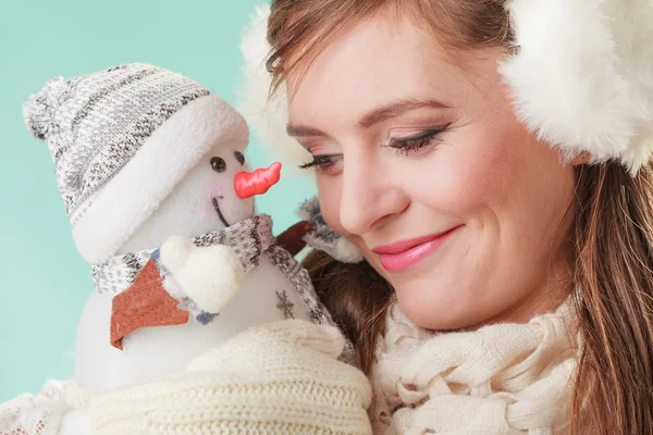 Cute woman holding little snowman — Stock Photo, Image