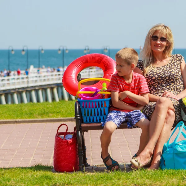 Happy woman and boy kid resting on bench. — Stock Photo, Image