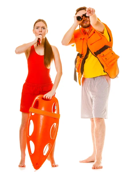 Lifeguards in life vest with rescue buoy whistling — Stock Photo, Image