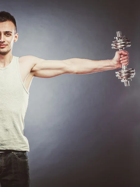 Athletic man working with heavy dumbbell — Stock Photo, Image