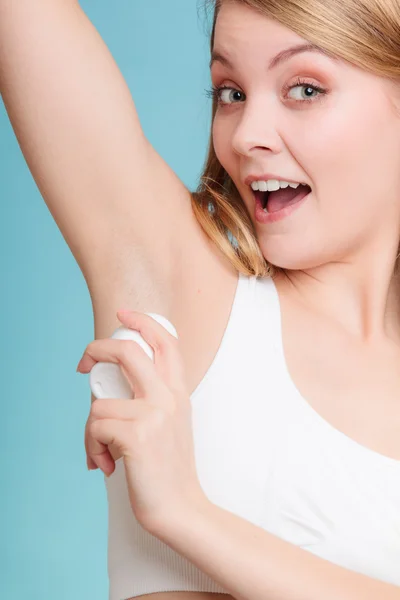 Girl applying stick deodorant in armpit. — Stock Photo, Image