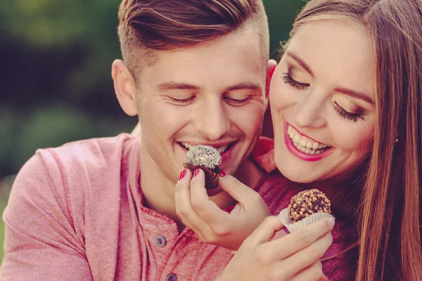 Smiling couple feeding each other.