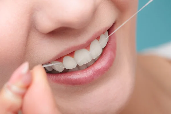 Woman using dental floss — Stock Photo, Image