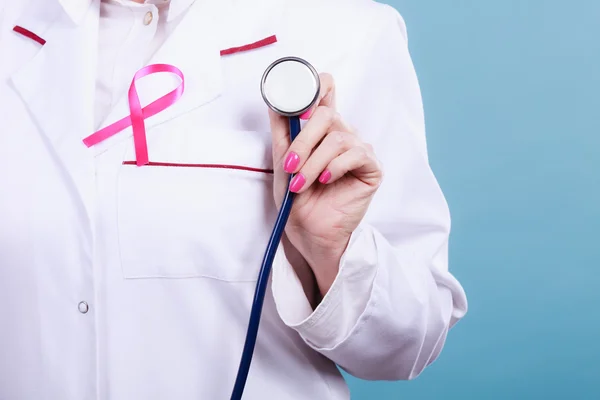 Pink ribbon with stethoscope on medical uniform. — Stock Photo, Image