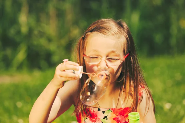 Little girl child blowing soap bubbles outdoor. — Stock Photo, Image