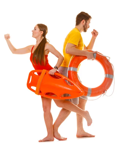 Lifeguards running with rescue ring buoy on duty. — Stock Photo, Image