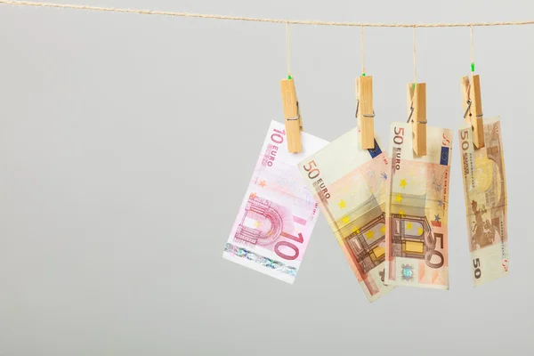 Banknotes on laundry line — Stock Photo, Image