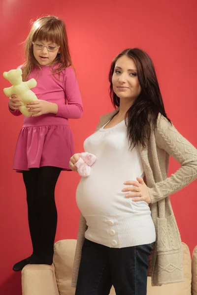 Pregnant woman with small shoes for unborn baby — Stock Photo, Image